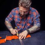 craftsman-working-with-leather-creates-new-leatherwork-his-leather-studio