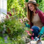portrait-happy-gardening-woman-gloves-hat-apron-plants-flowers-flower-bed-home-garden